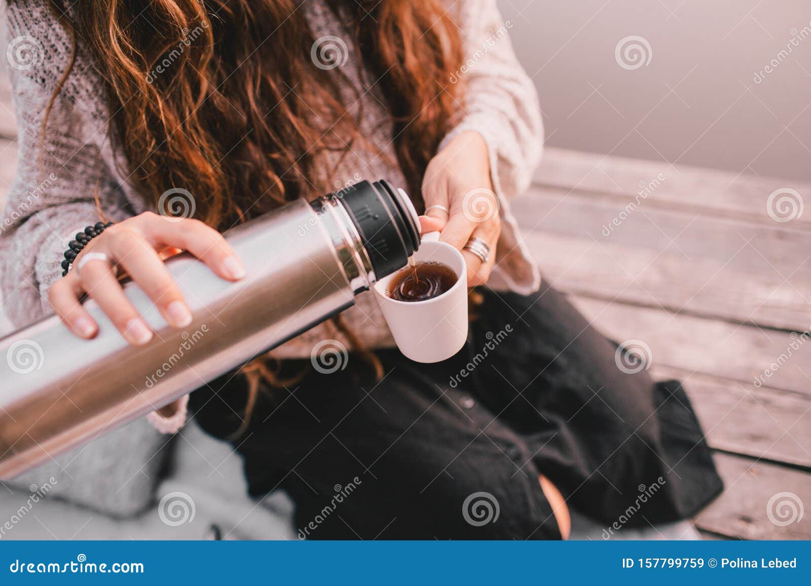 Happy Woman In Sweater Pouring Tea From Thermos In Cup Stock