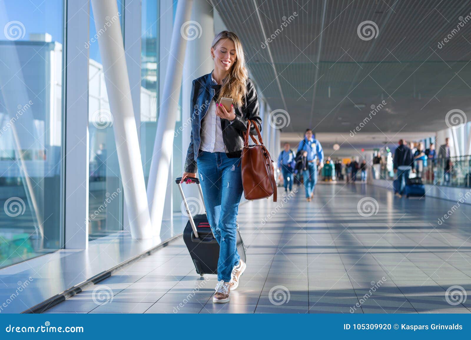 happy woman travelling and walking in airport