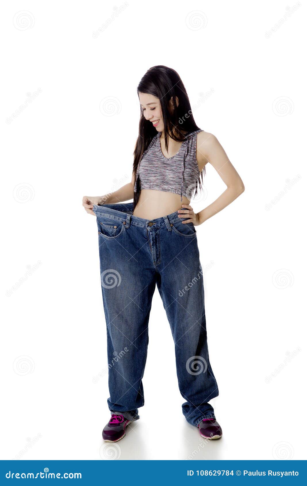 Happy Woman Trying Her Old Jeans on Studio Stock Photo - Image of diet ...