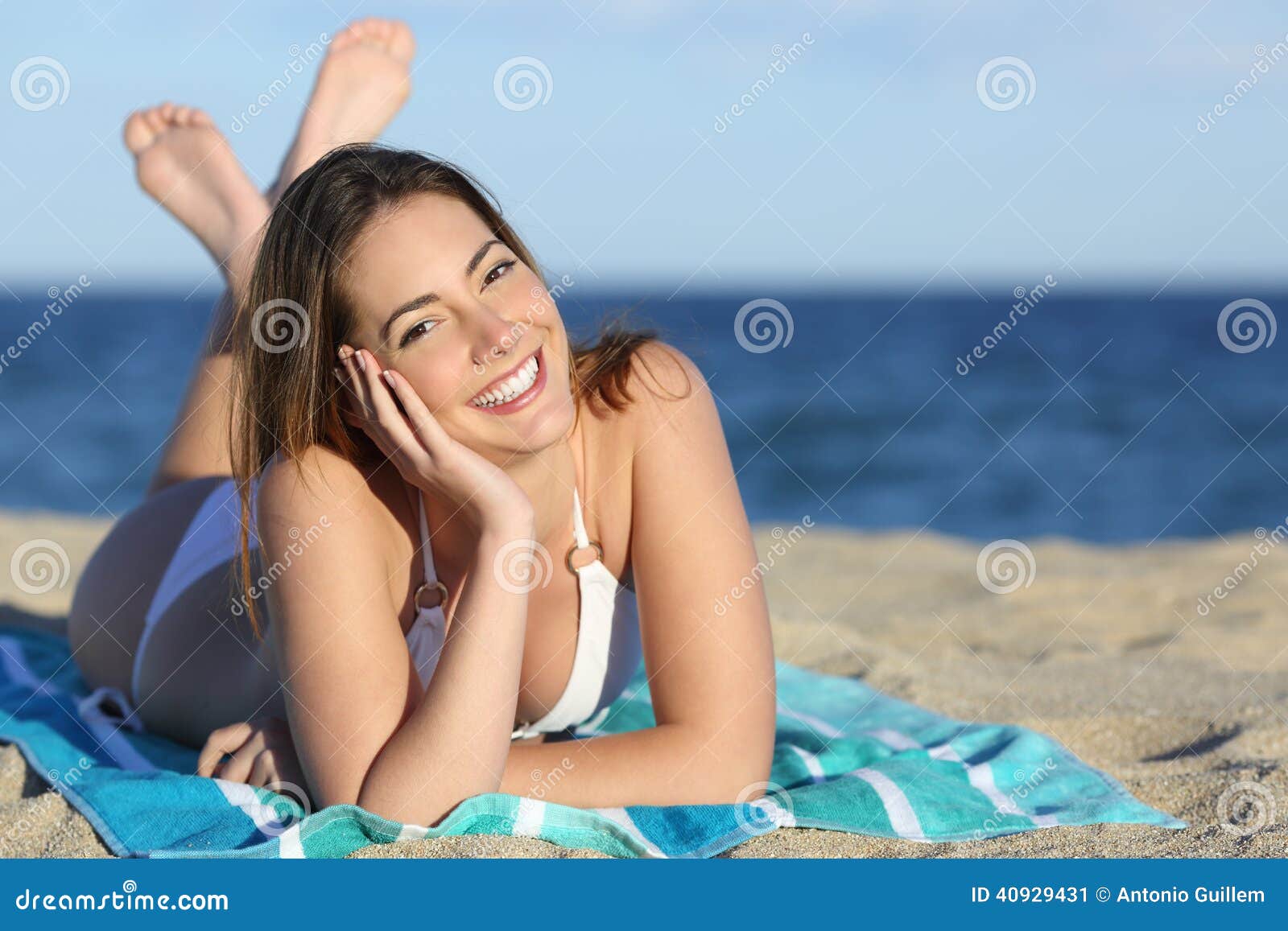 happy woman with white perfect smile resting on the beach