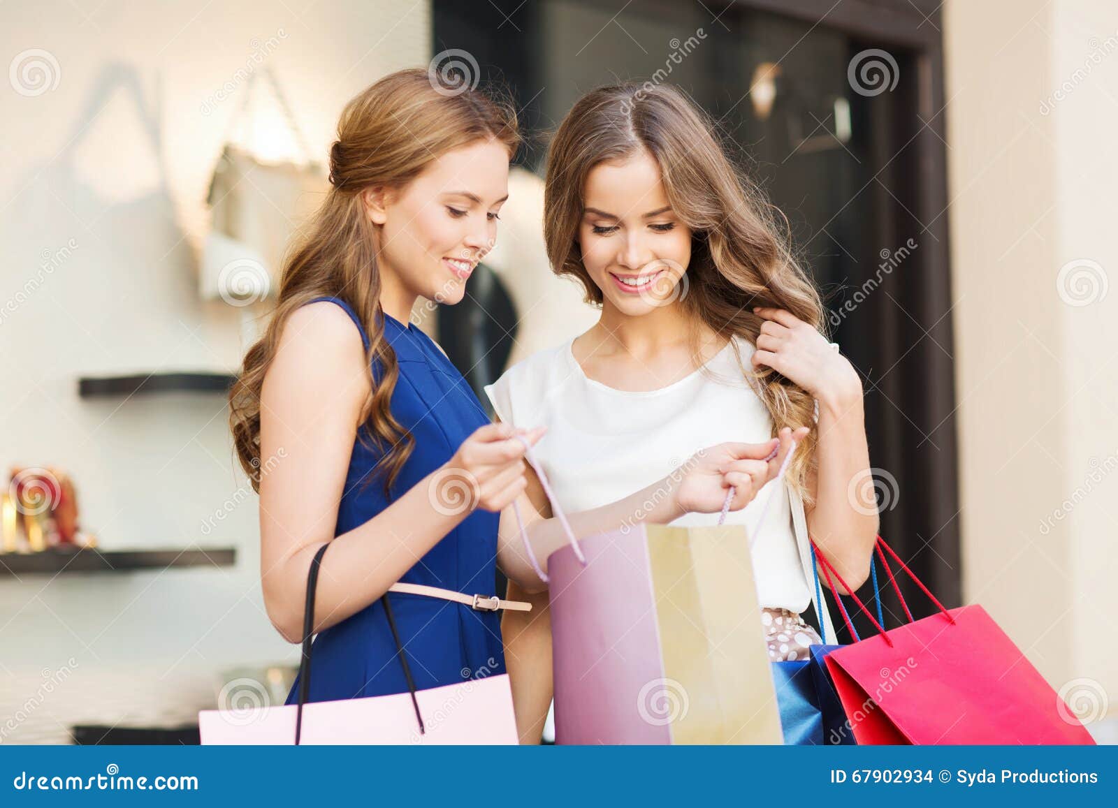 Happy Women with Shopping Bags at Shop Window Stock Photo - Image of ...