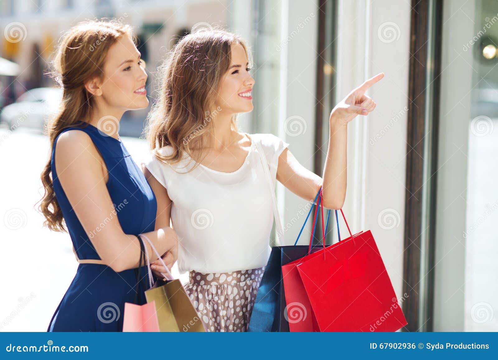 Happy Women with Shopping Bags at Shop Window Stock Photo - Image of ...