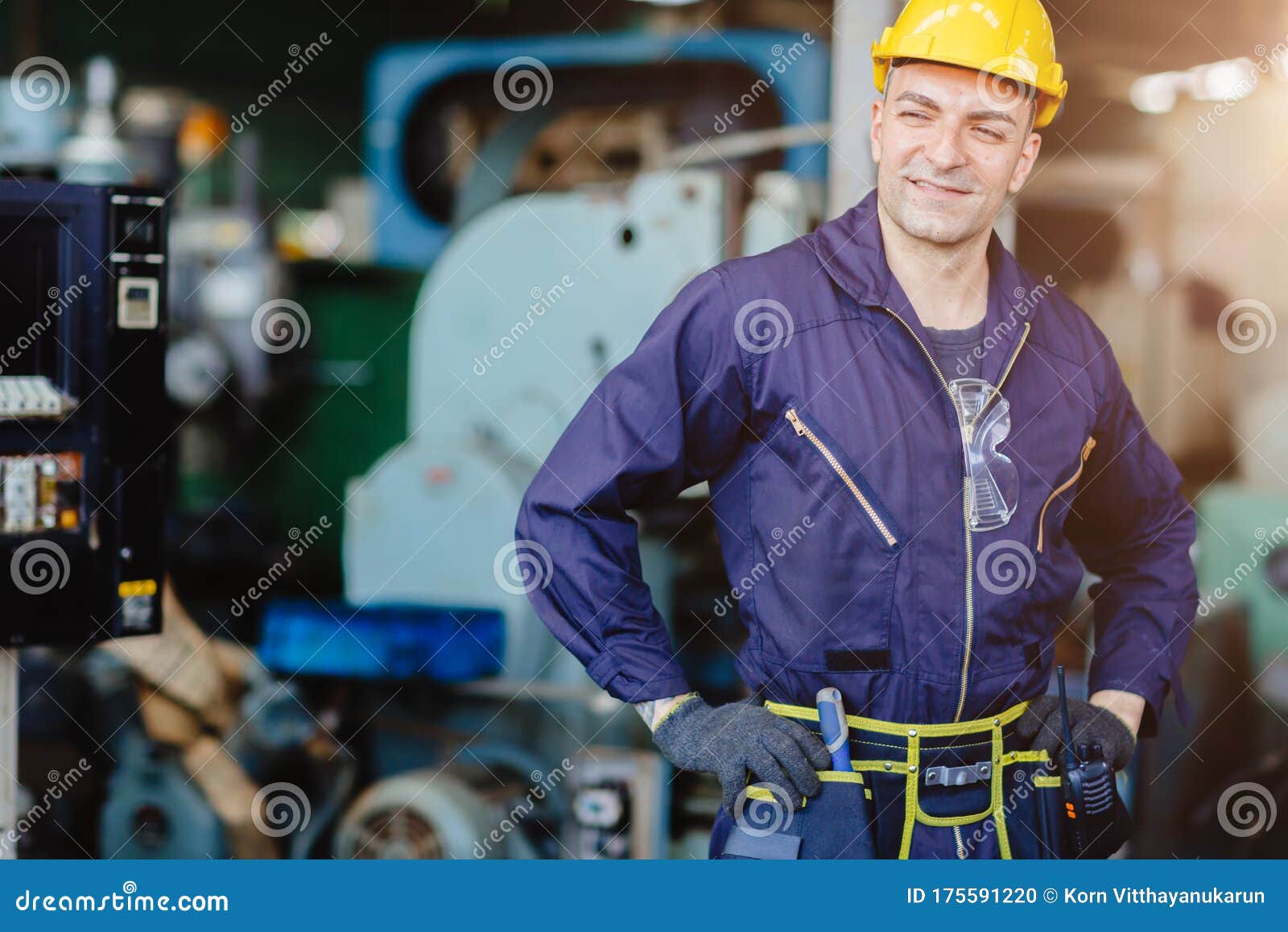 happy worker.engineer smiling for service maintenance fix machine in heavy industy with safty suit and helmet