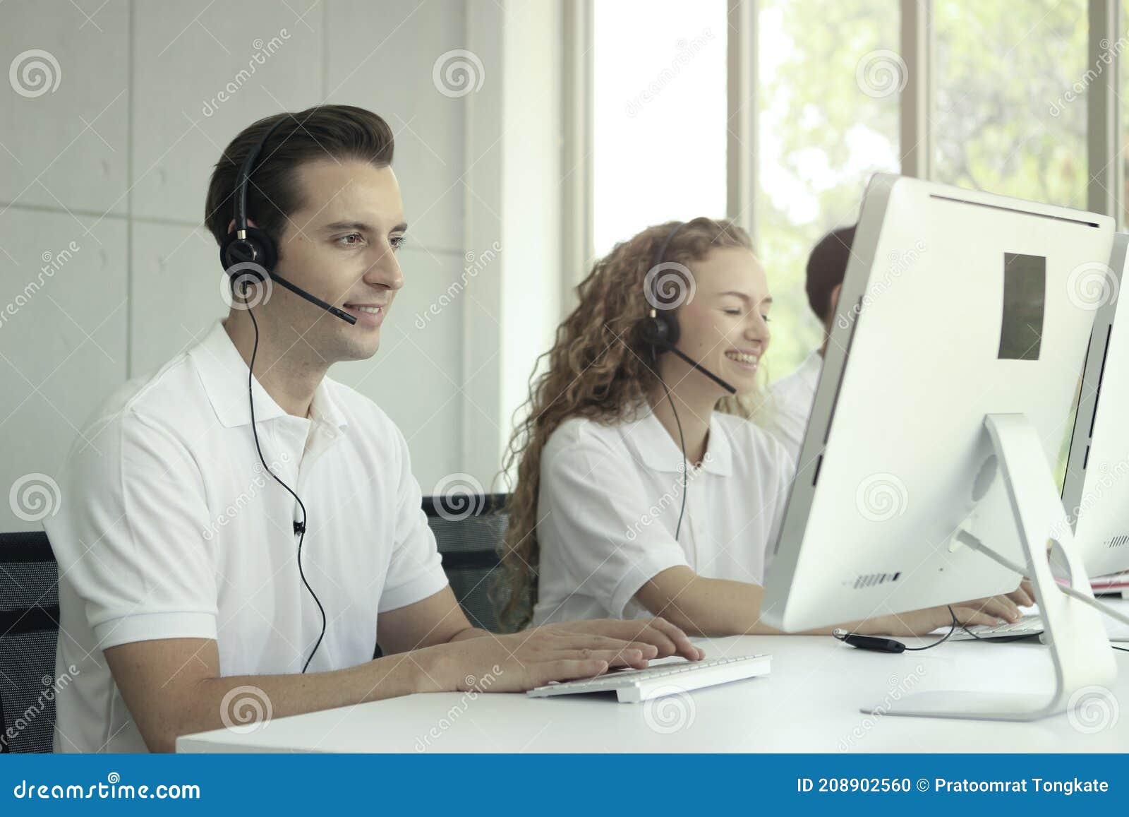Happy Worker Staff with Headphones Working at Call Center Service Desk