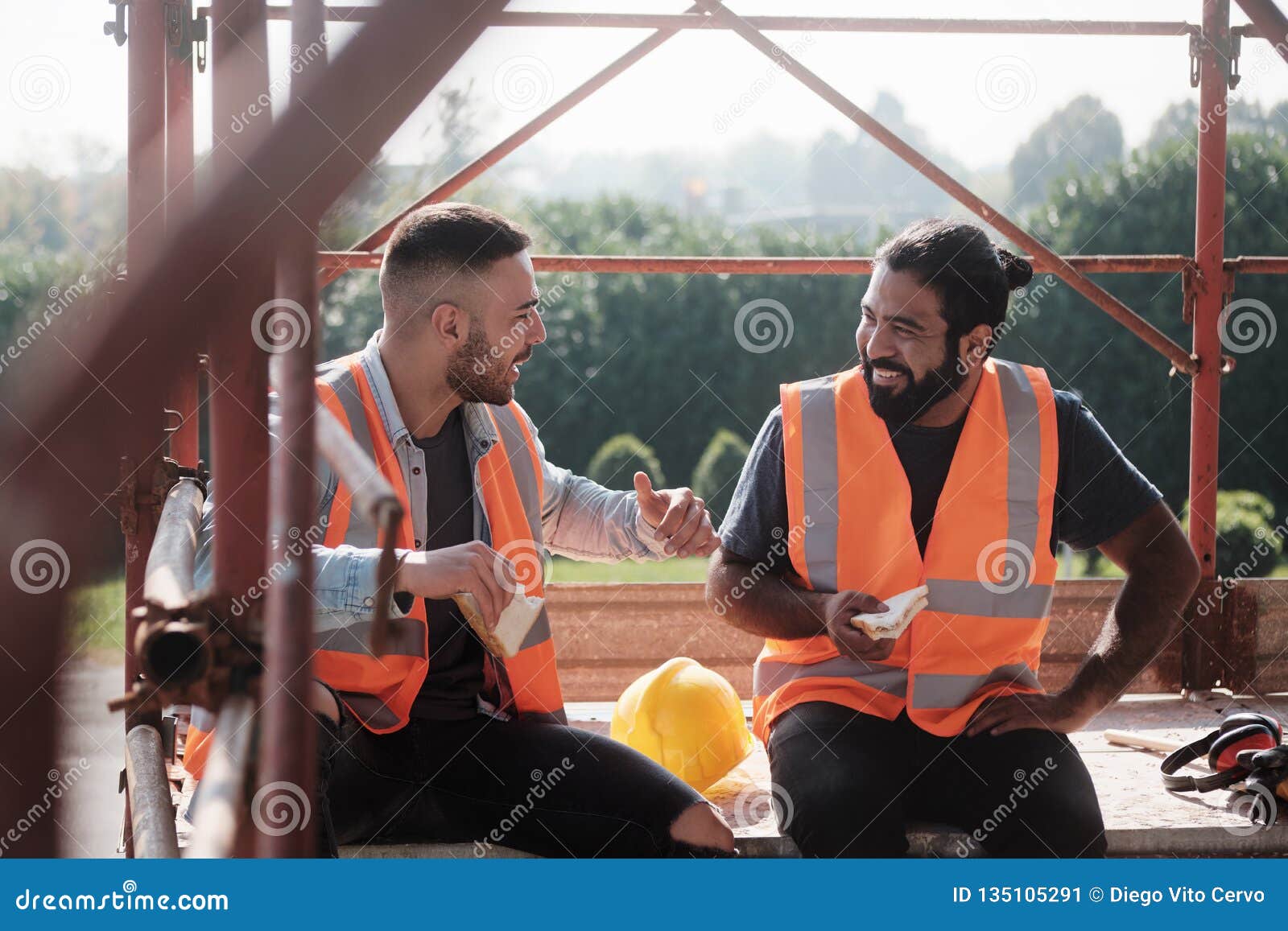 happy workers in construction site during lunch break