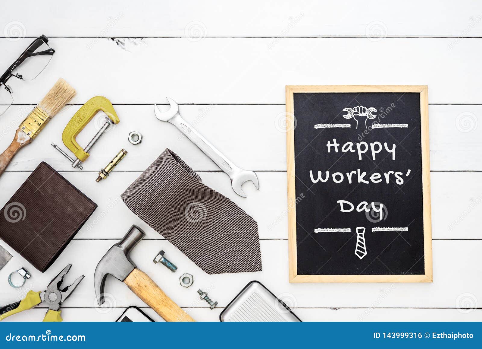 happy workers` day background concept. flat lay of construction blue collar handy tools and white collar`s accessories over wood