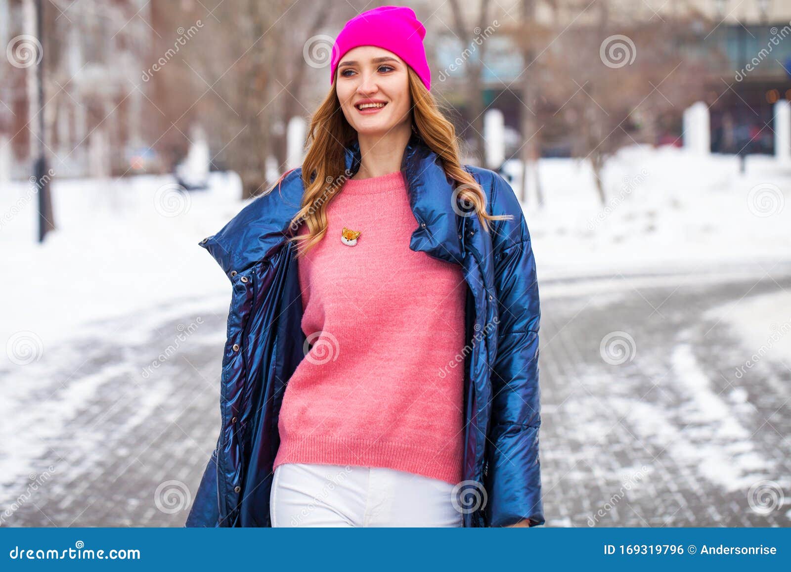 Young Blonde Woman in Blue Down Jacket in Winter Street Stock Photo ...