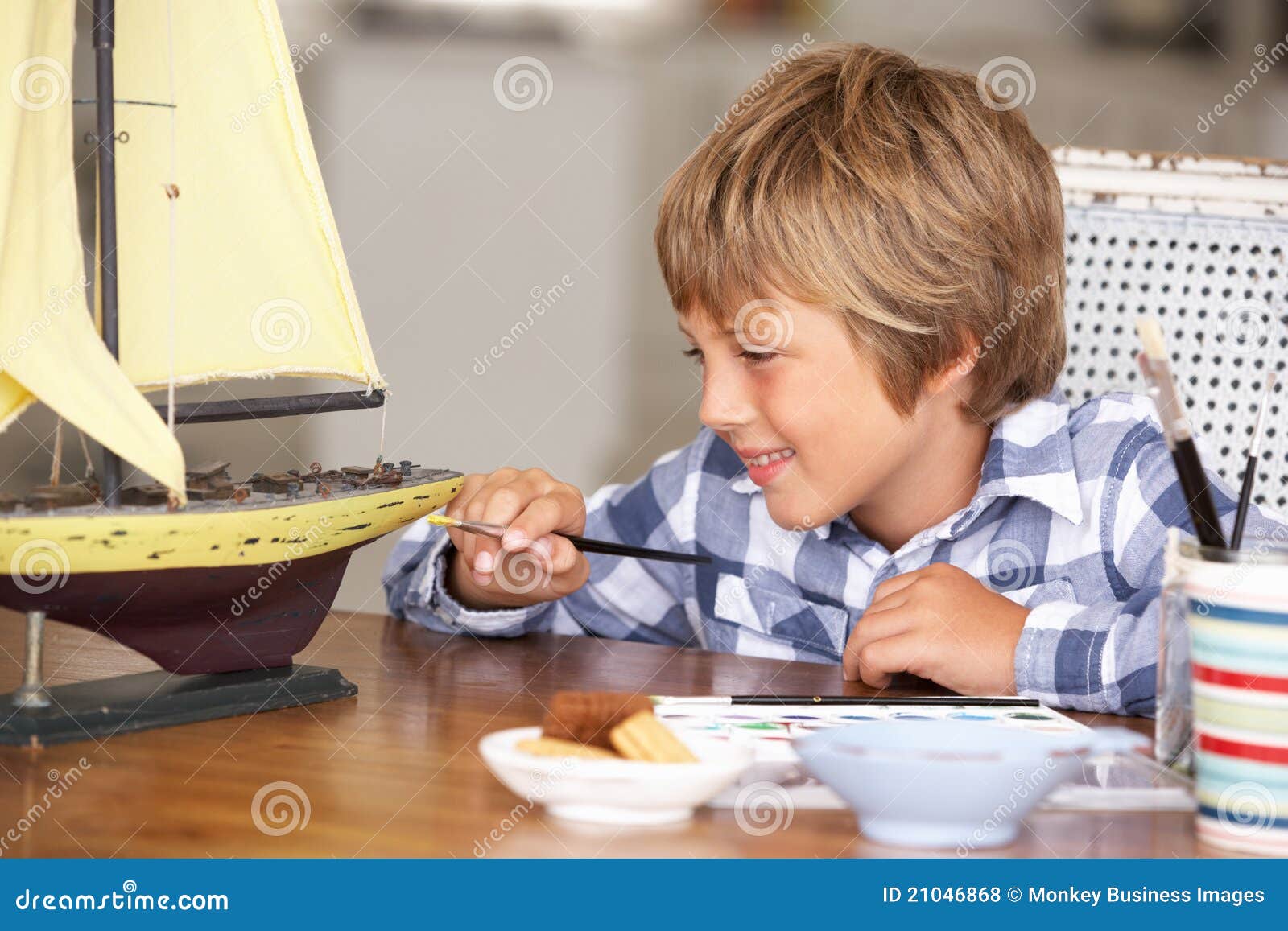 happy young boy making model ship stock photo - image of