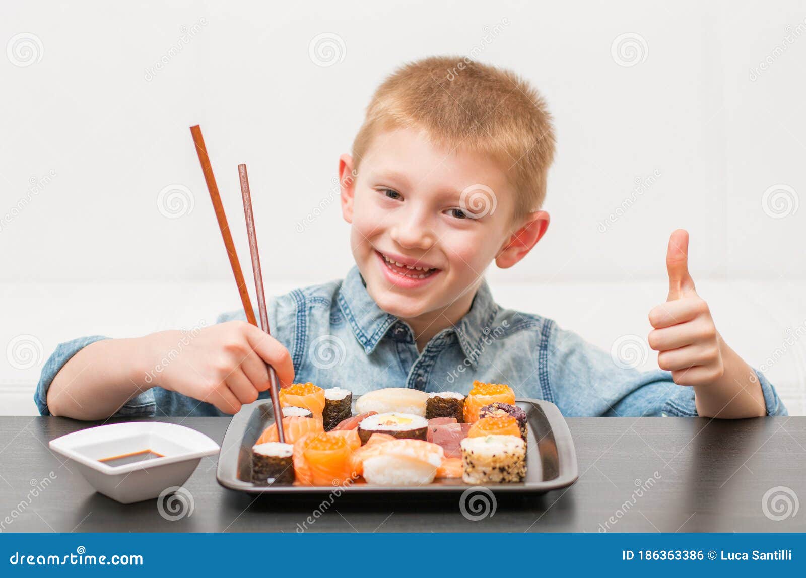 An Happy Young Boy Ready for Eating Sushi Stock Photo - Image of happy