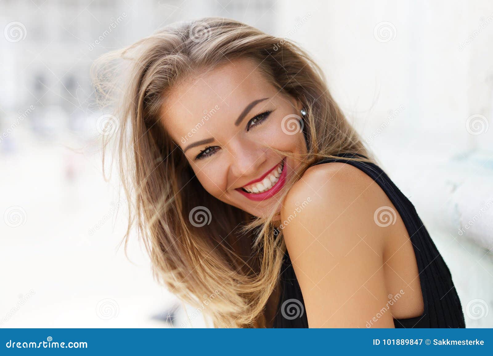 happy young carefree woman smiling outdoor portrait