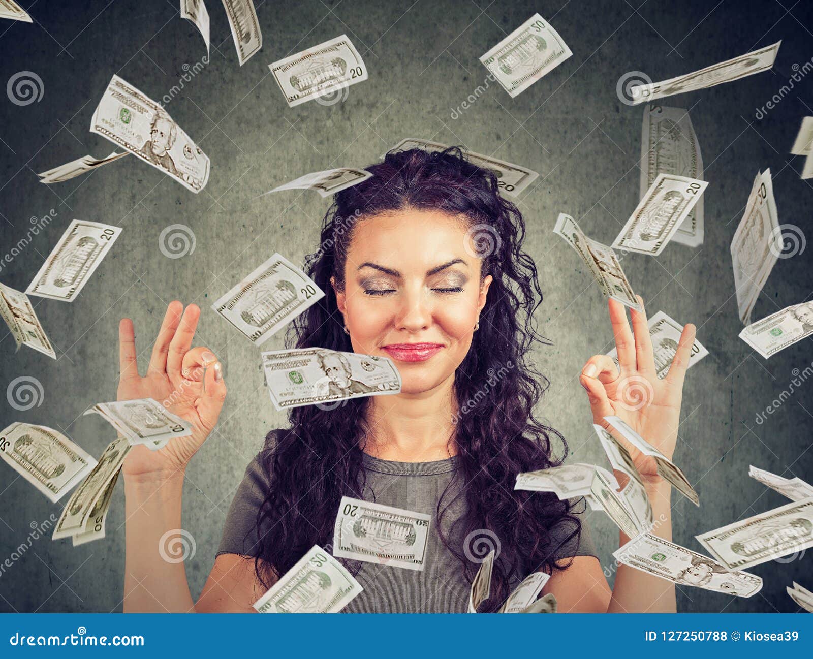 woman meditating under money rain