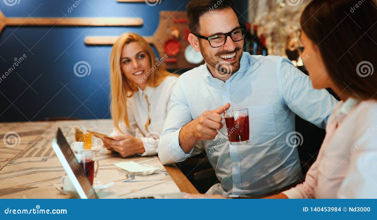 happy colleagues from work socializing in restaurant