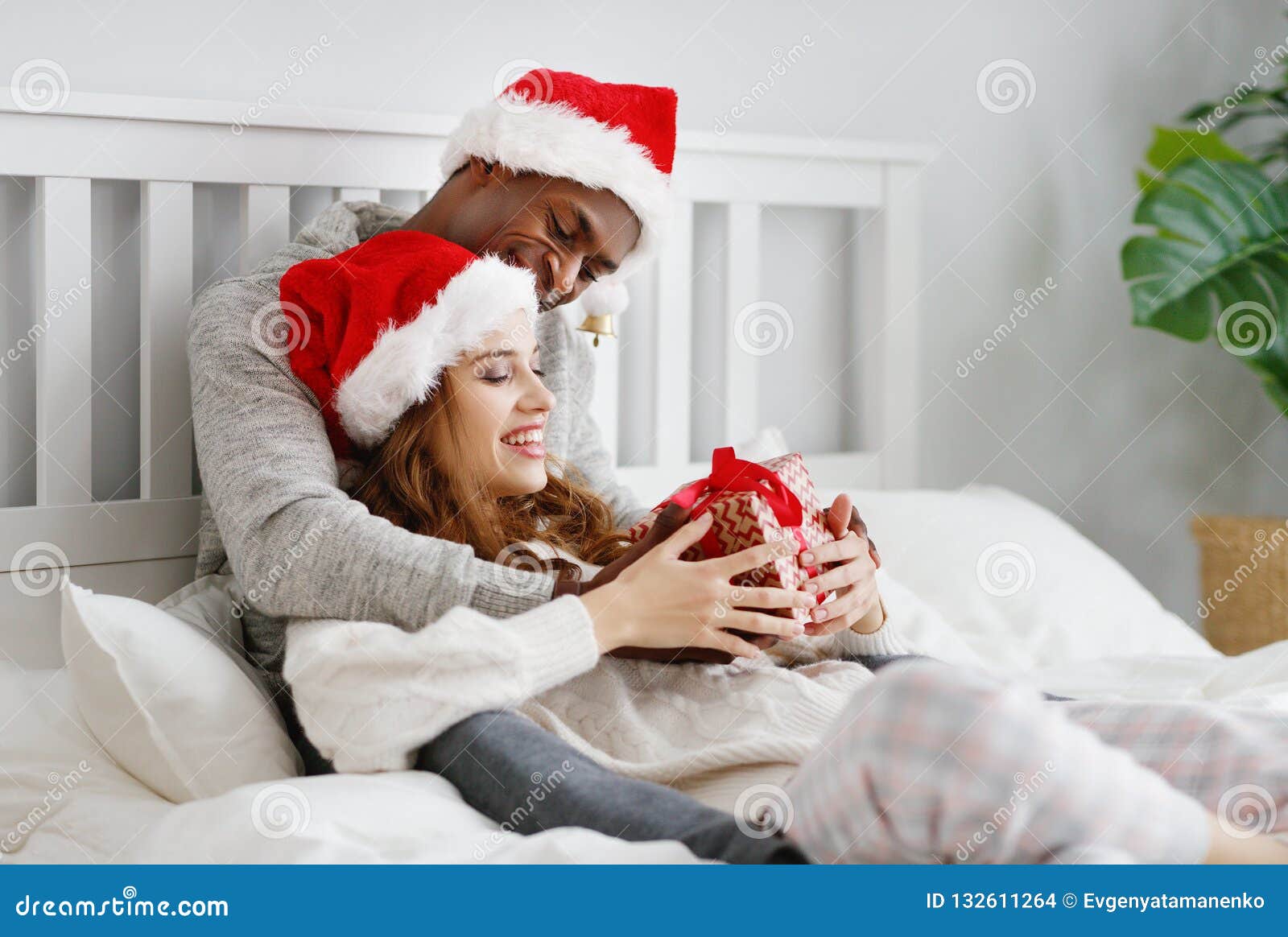 Happy Young Couple with Gifts on Christmas Morning in Bed Stock ...