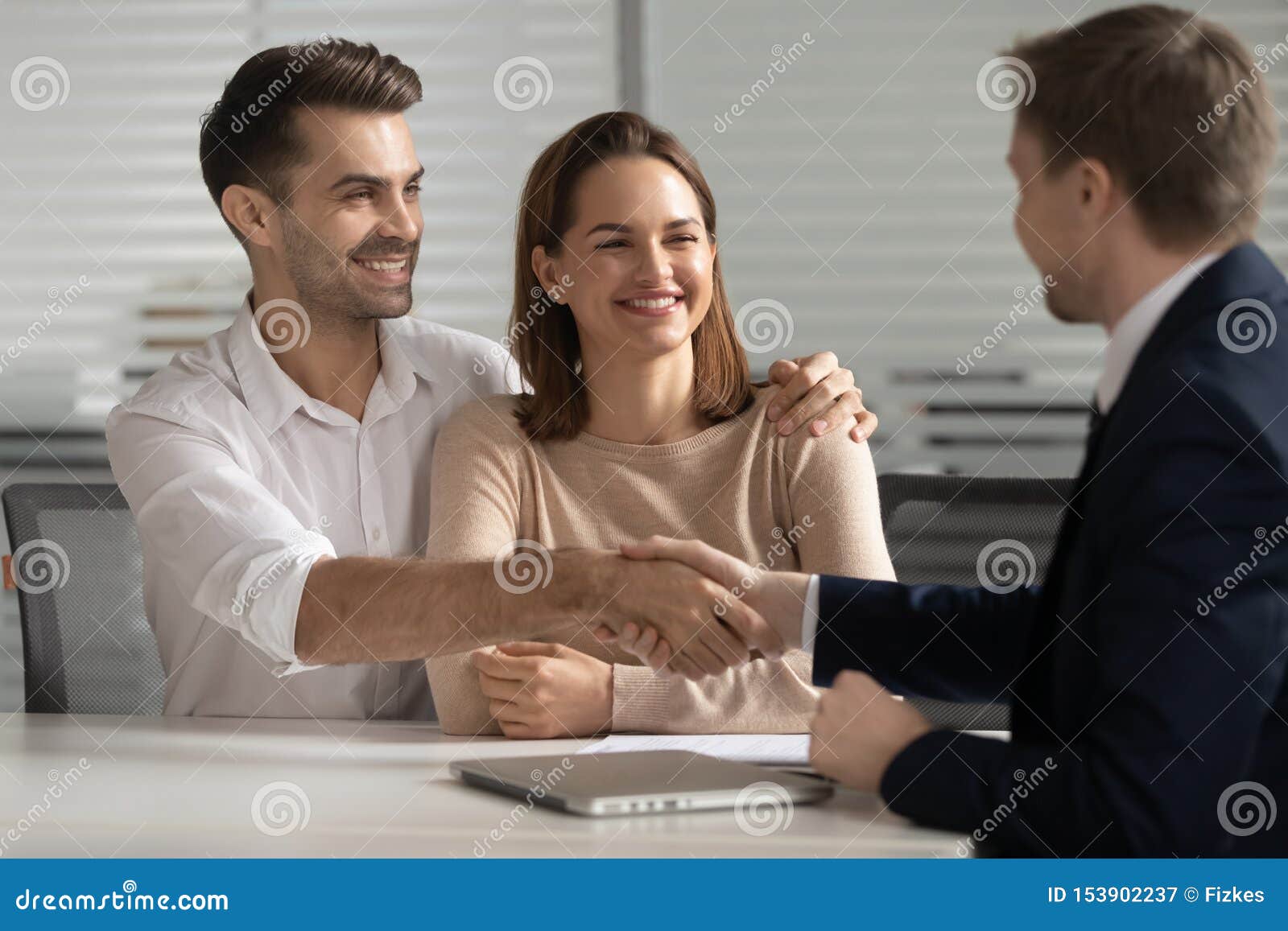 happy young couple handshake lawyer insurer broker make business deal