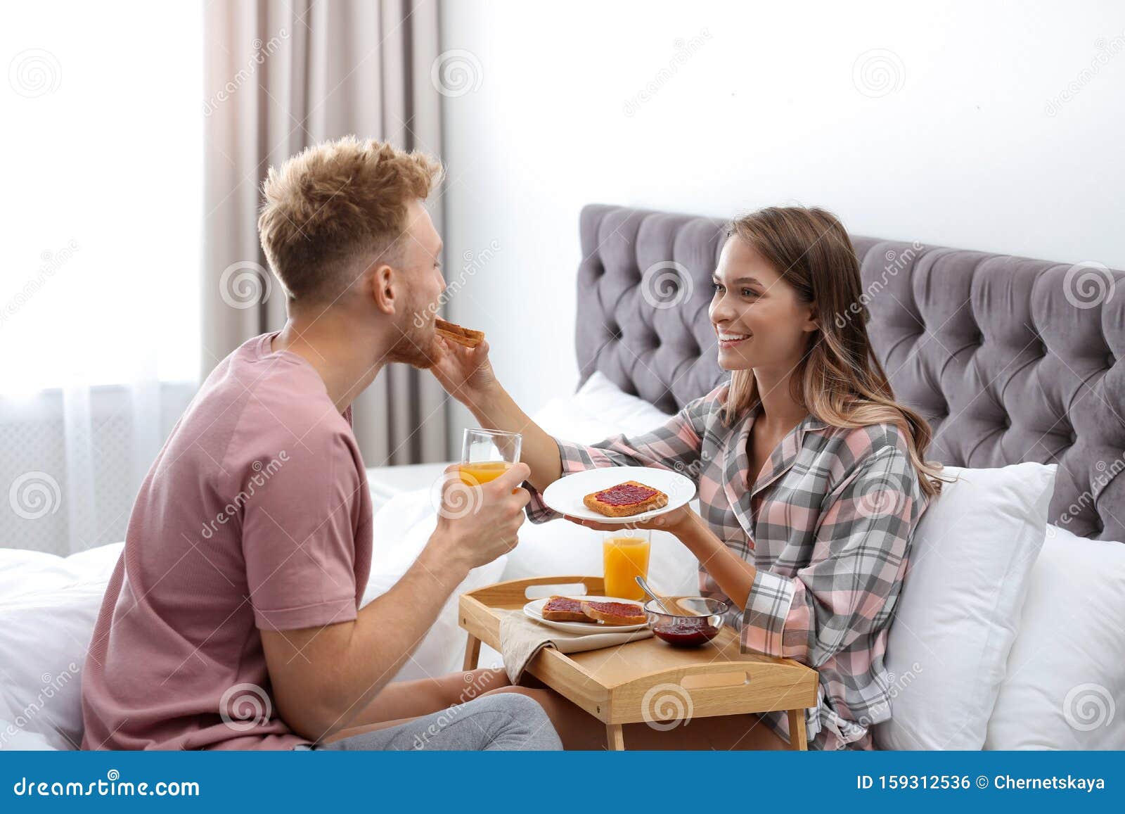 Happy Young Couple Having Romantic Breakfast on Bed Stock Photo Image