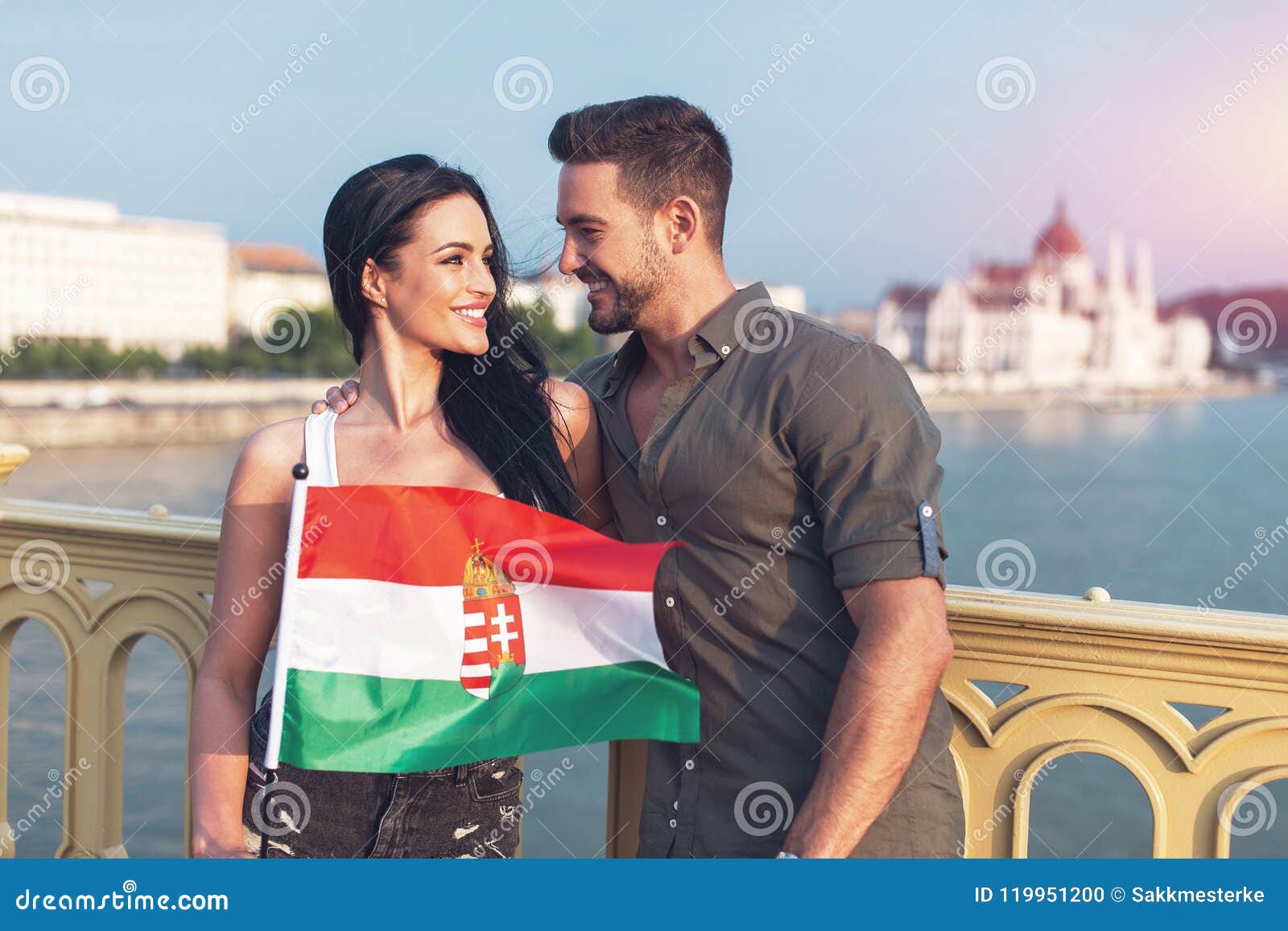 Happy Young Couple With Hungarian Flag Looking To Each Other Stock