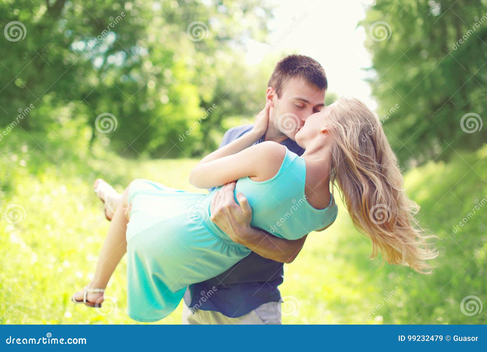 Happy Young Couple is Kissing, Man and Woman in Love, Holds on a ...