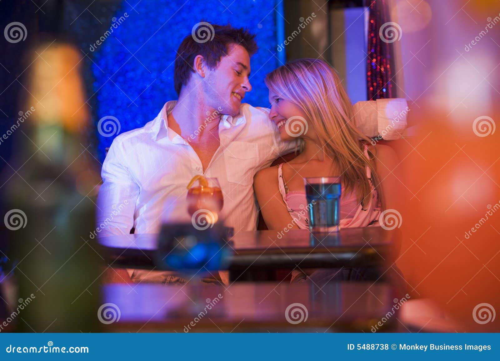 https://thumbs.dreamstime.com/z/happy-young-couple-sitting-nightclub-smiling-5488738.jpg