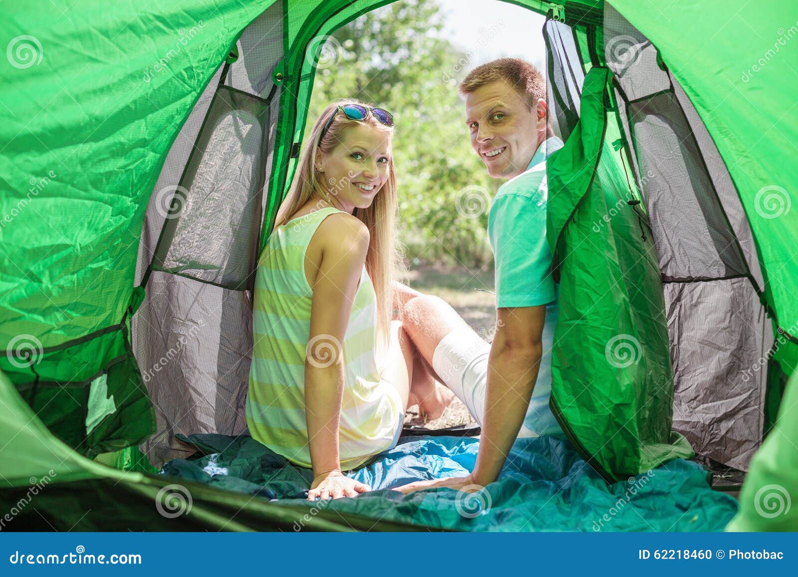 Happy Young Couple in a Tent. Stock Photo Image of smiling, tent