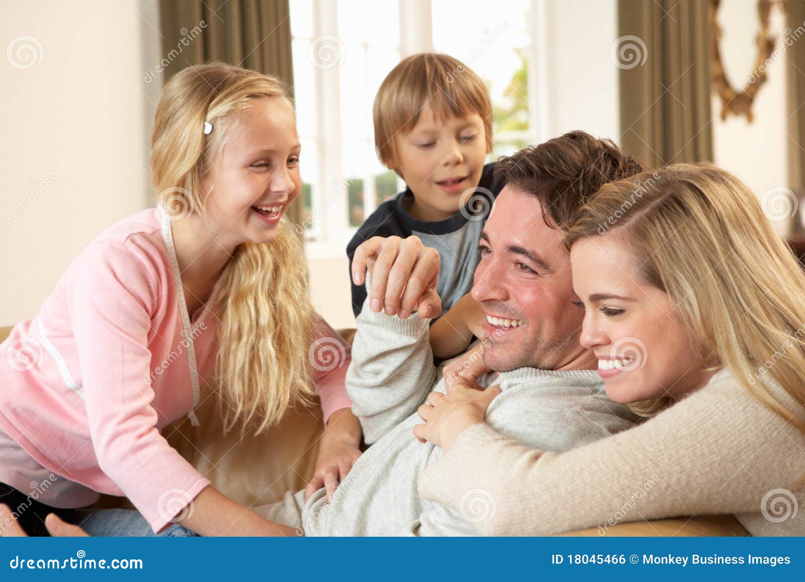 Happy Young Family Playing Together On Sofa Royalty Free Stock Image