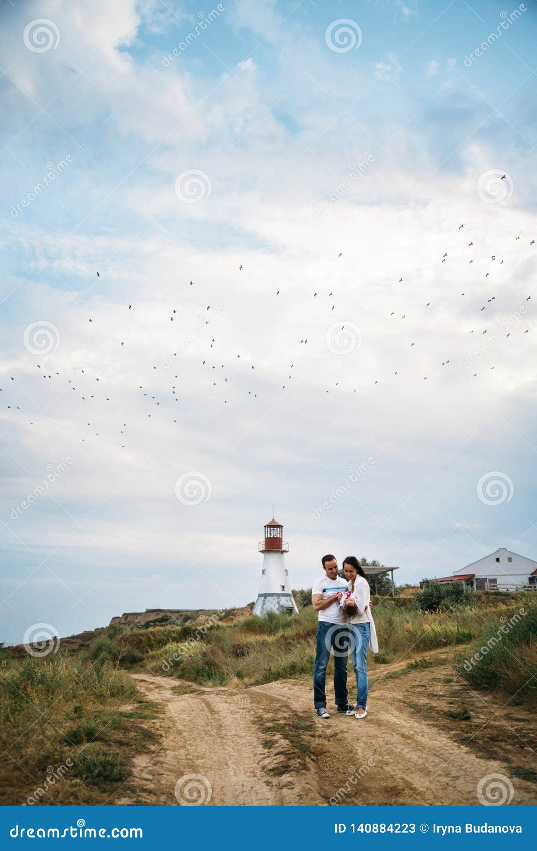 Happy Young Family in White T-shirts and Blue Jeans with a Small ...