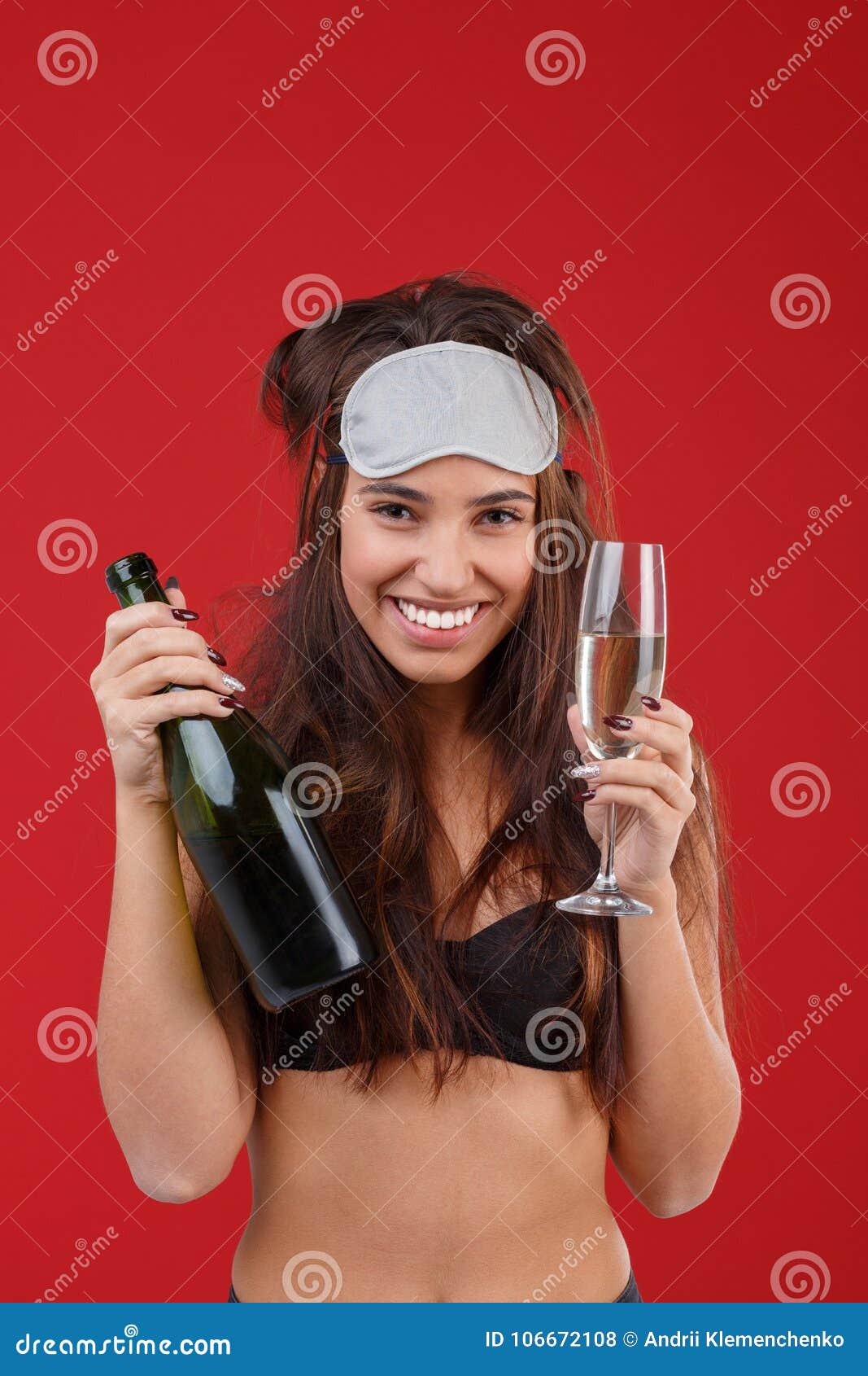 A Happy Young Girl in a Bra and a Mask for Sleeping, Holding a Bottle of  Alcohol and a Glass and Smiling Cheerfully. Stock Photo - Image of hand,  alcohol: 106672108