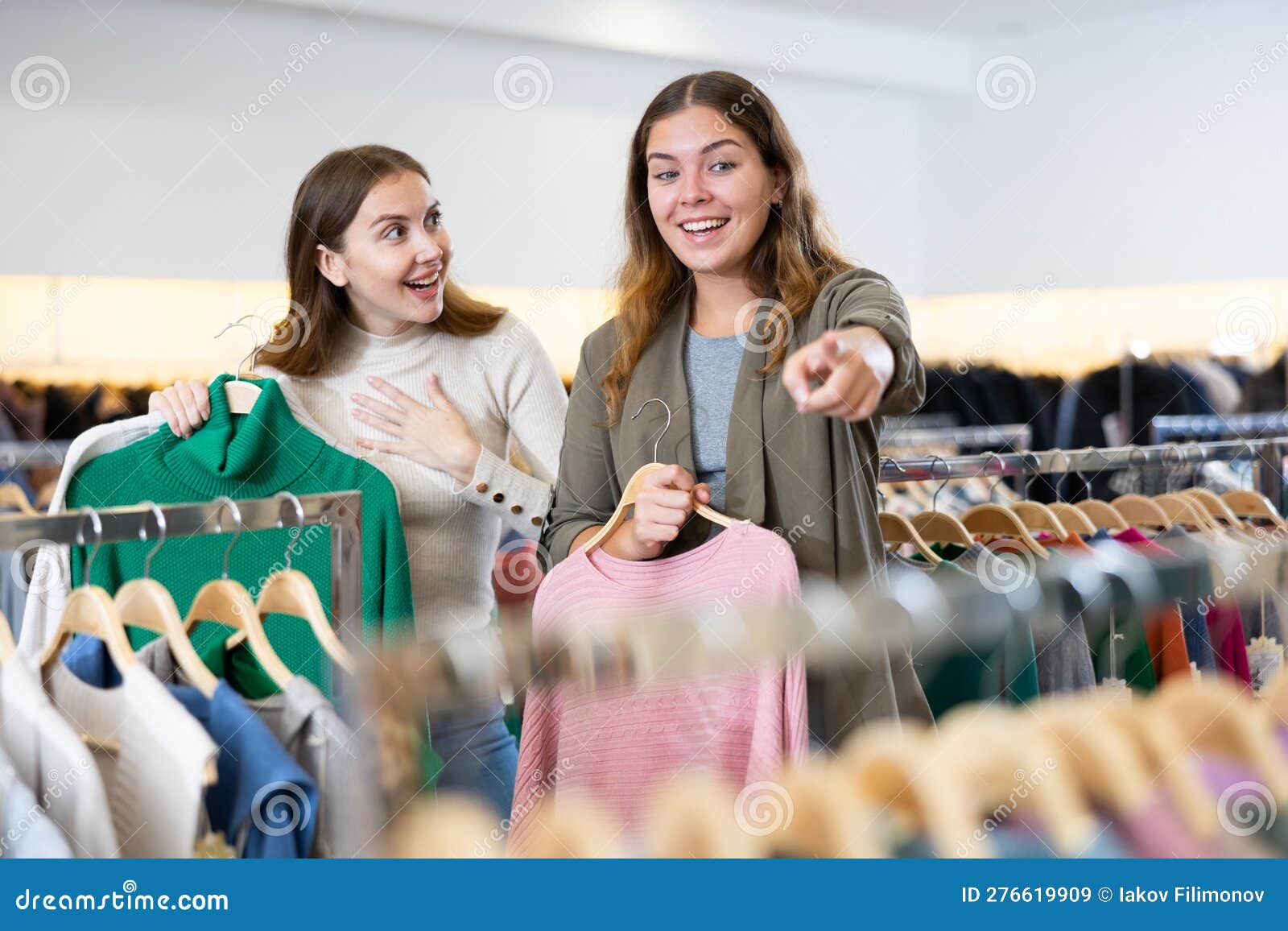 Happy Girls Pointing Finger at New Clothes in Clothing Store Stock ...