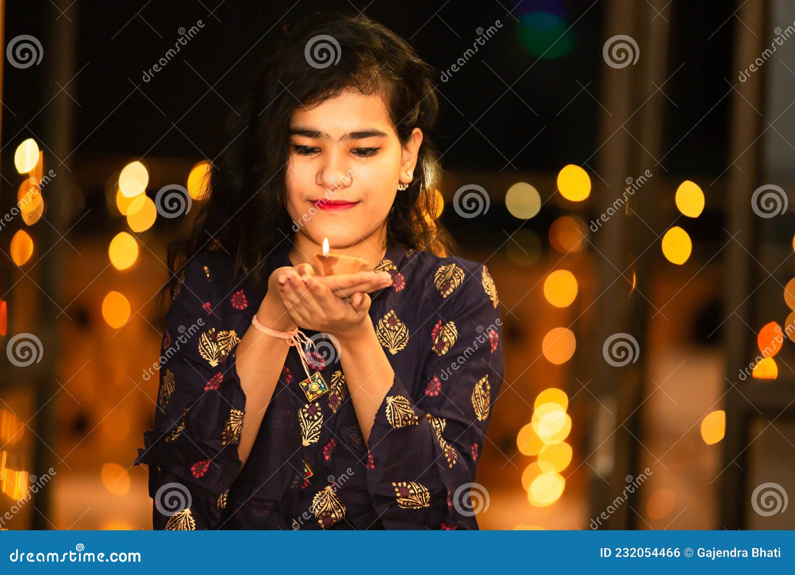 Image of A girl light lamps on the occasion of Diwali festival in Nagaon  District of Assam on Nov 14,2020.-NF009619-Picxy