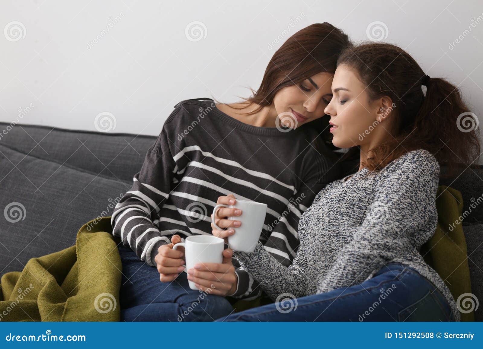 Happy Young Lesbian Couple Drinking Coffee At Home St