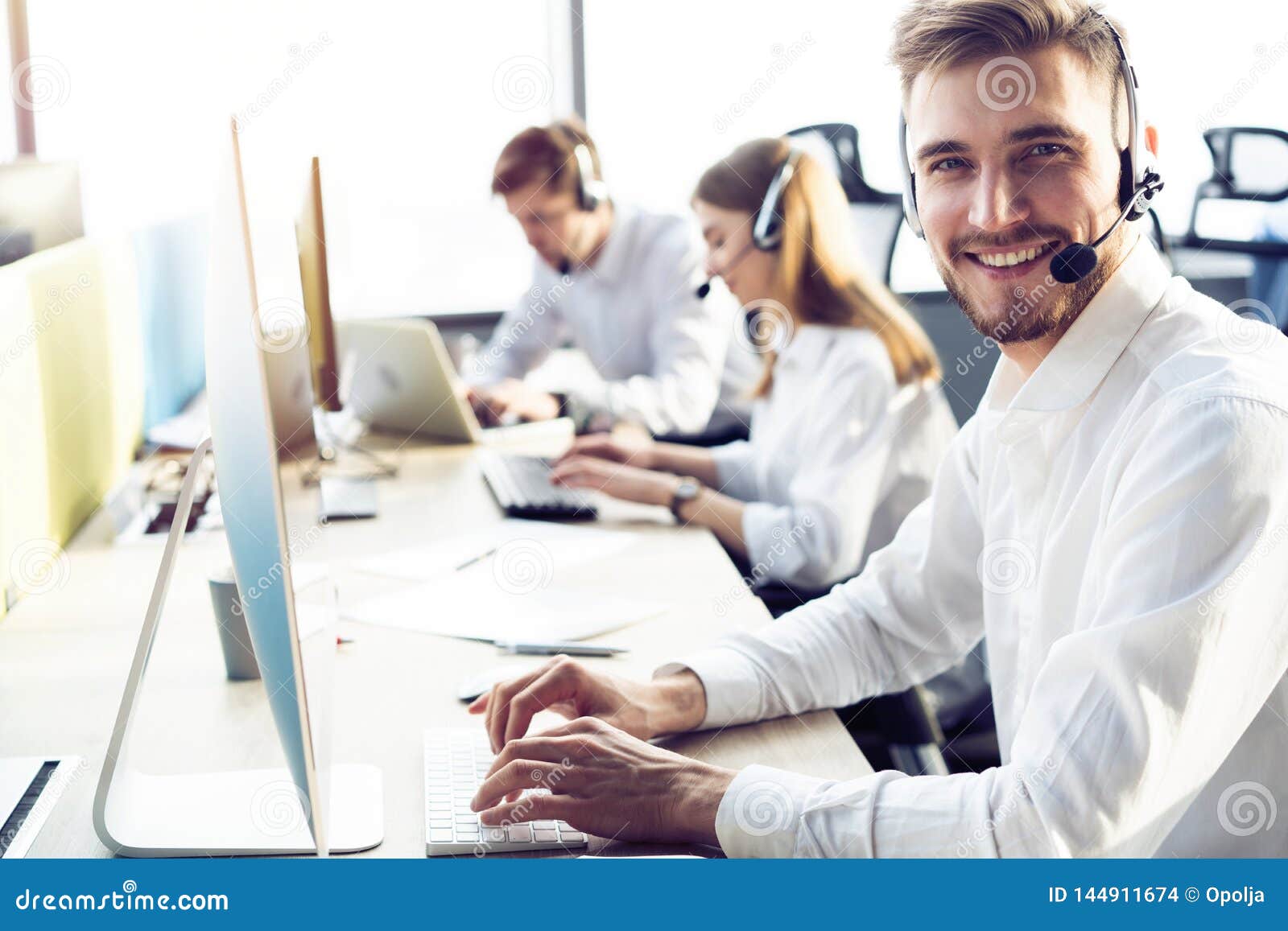 Happy Young Male Customer Support Executive Working in Office. Stock Photo Image of looking