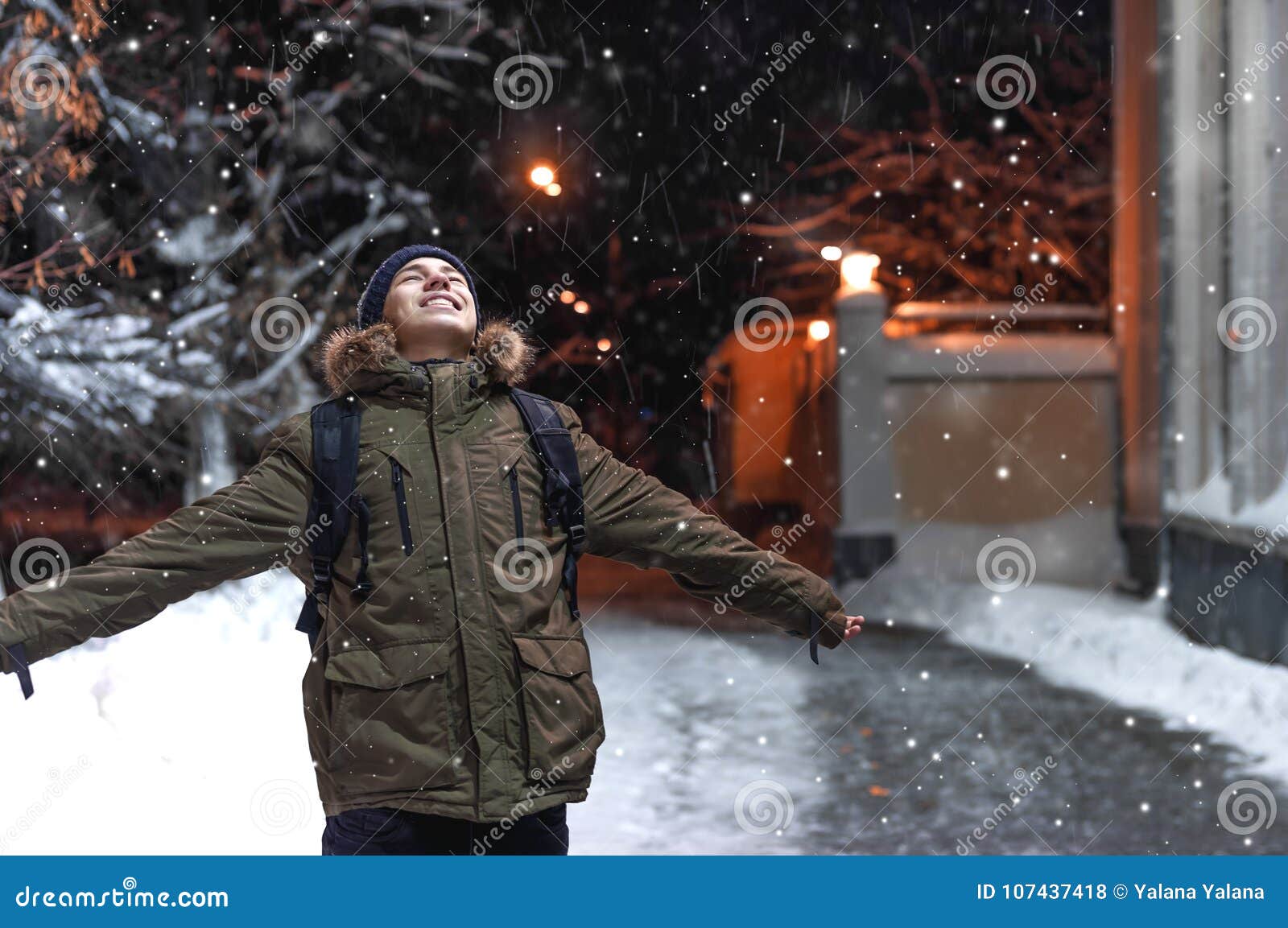 Download Happy Young Man A City Street During A Snowfall Stock Image of