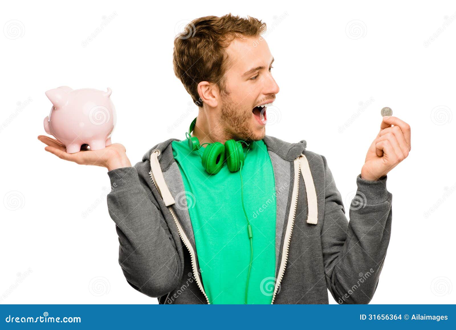 Happy Young Man Putting Money In Piggy Bank Isolated On White Stock