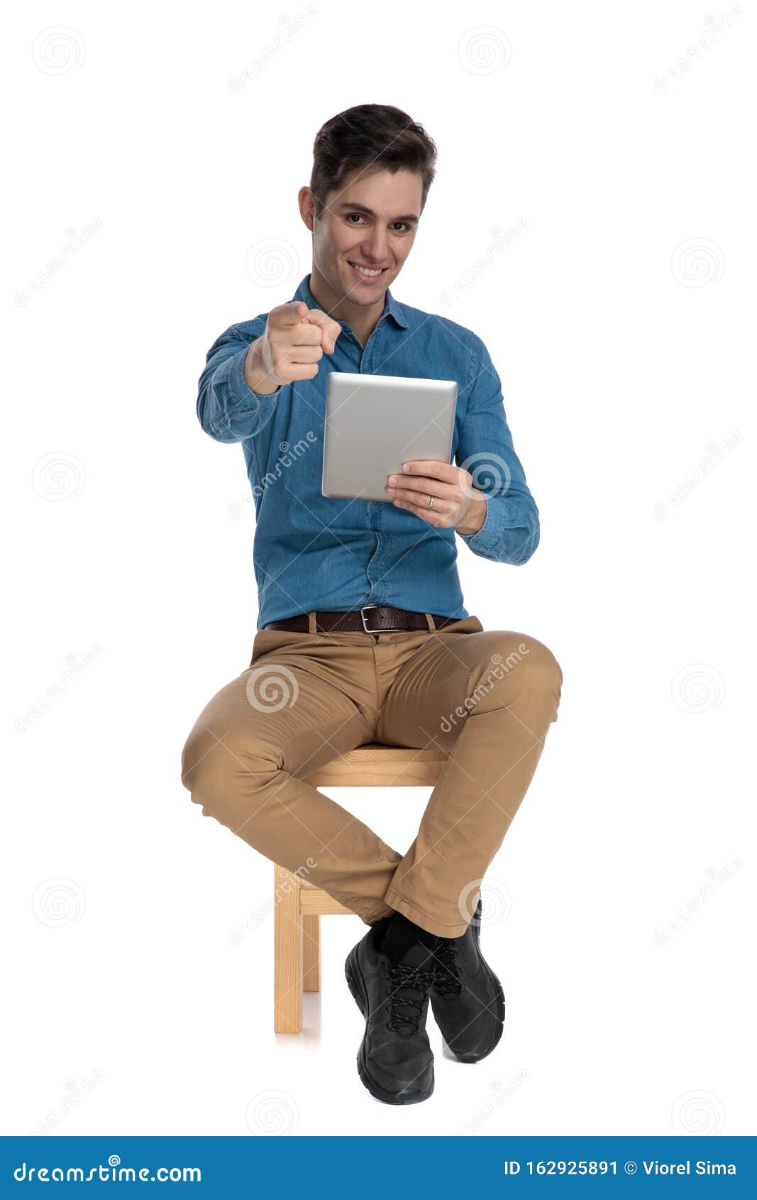 Happy Young Man Smiling, Holding Tab And Pointing Finger Stock Image ...