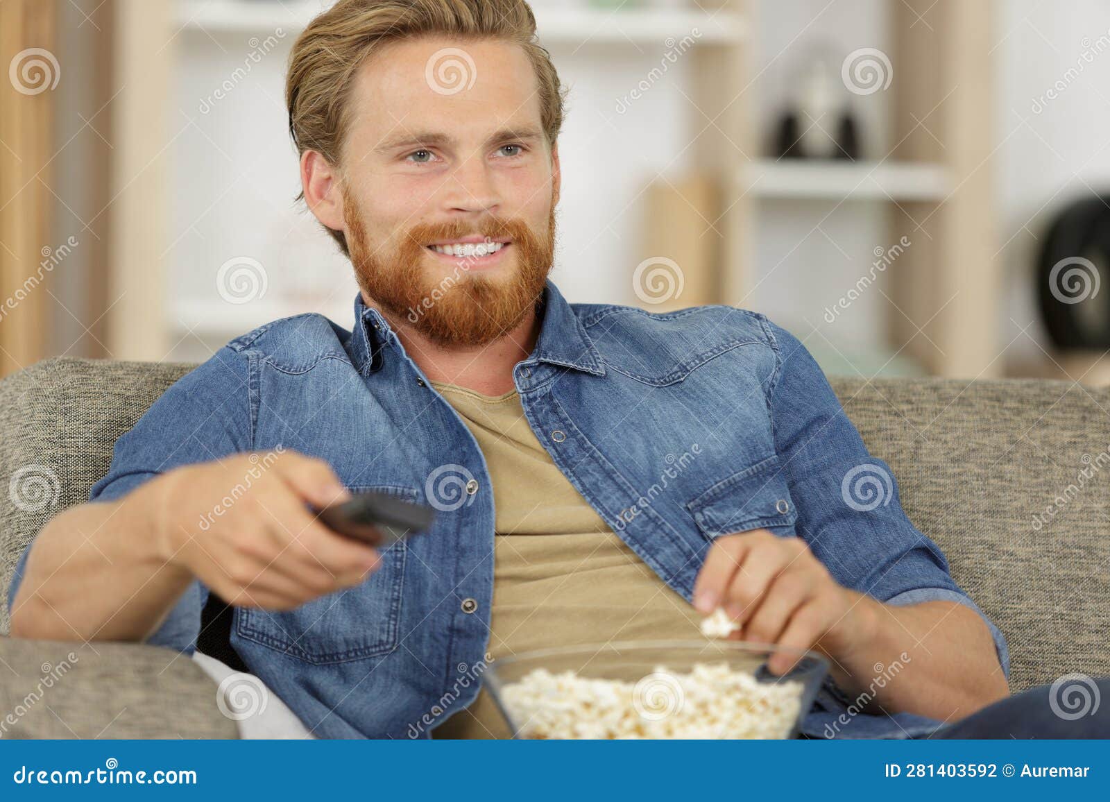 Happy Young Man Watching Tv and Eating Popcorn Stock Photo Image of