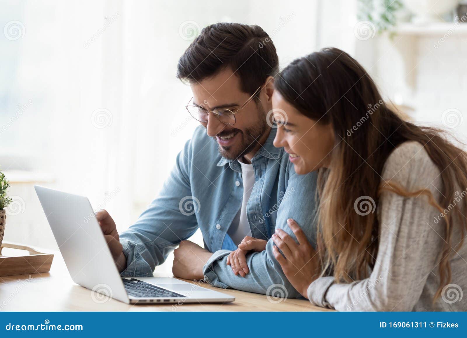 Happy Young Mixed Race Couple Watching Funny Videos on Computer. Stock  Image - Image of internet, house: 169061311
