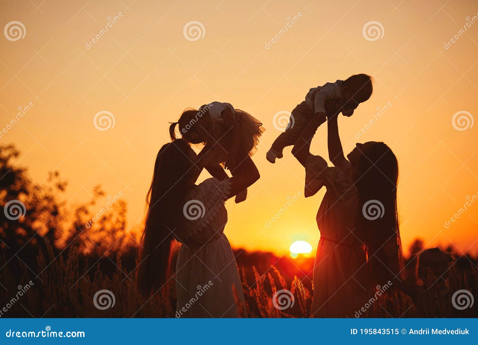 happy young moms playing with their kids outdoors in summer. happy family time together concept. selective focus