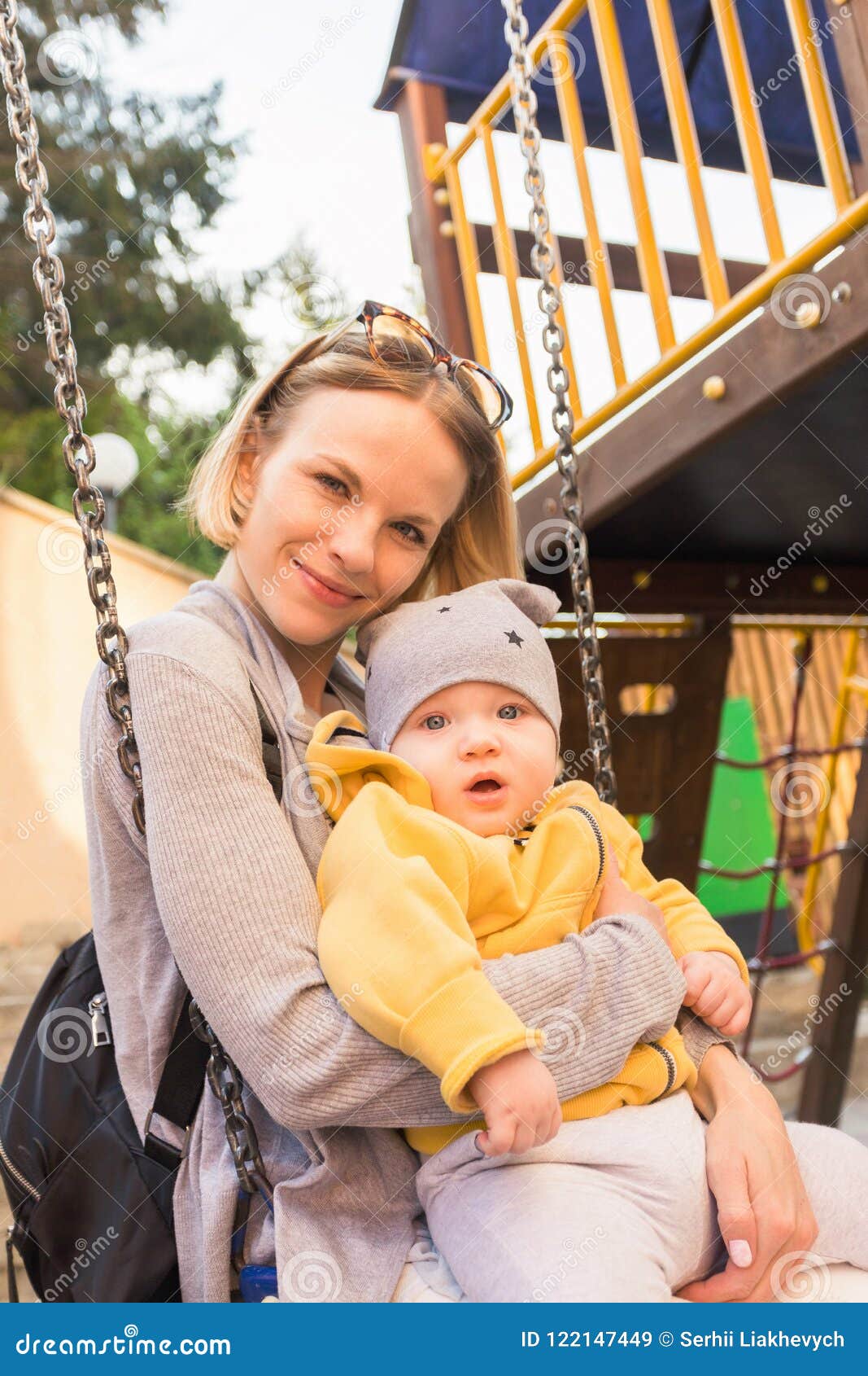 Mom and Son Ride on a Swing in the Playground Stock Image pic picture