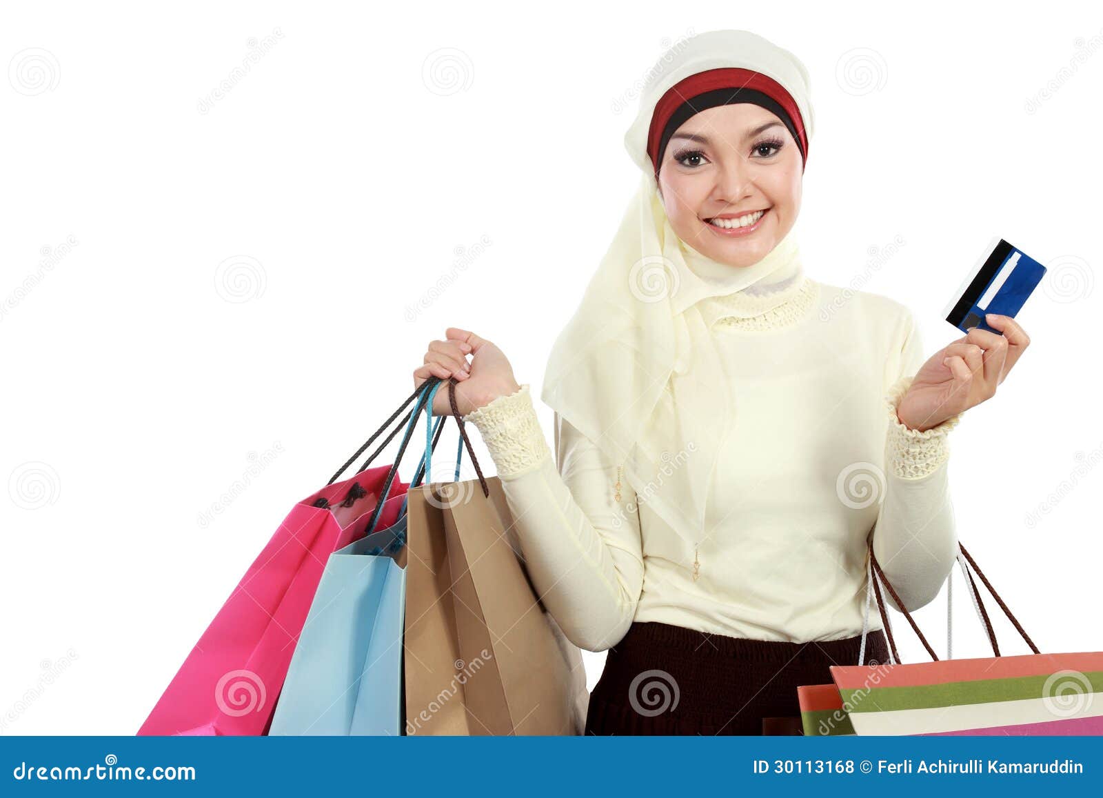 asian muslim couple shopping online on pad in living room stock