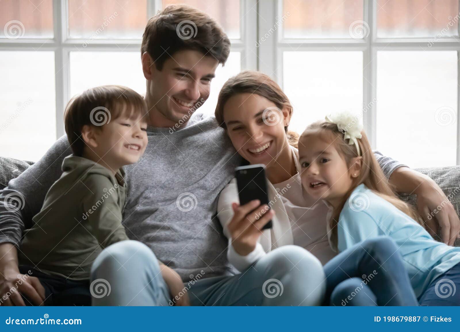 Happy Parents Relax on Couch Using Cell with Kids Stock Image - Image of device, candid: 198679887 Happy Parents Relax on Couch Using Cell with Kids Stock Image - Image of device, candid: 198679887