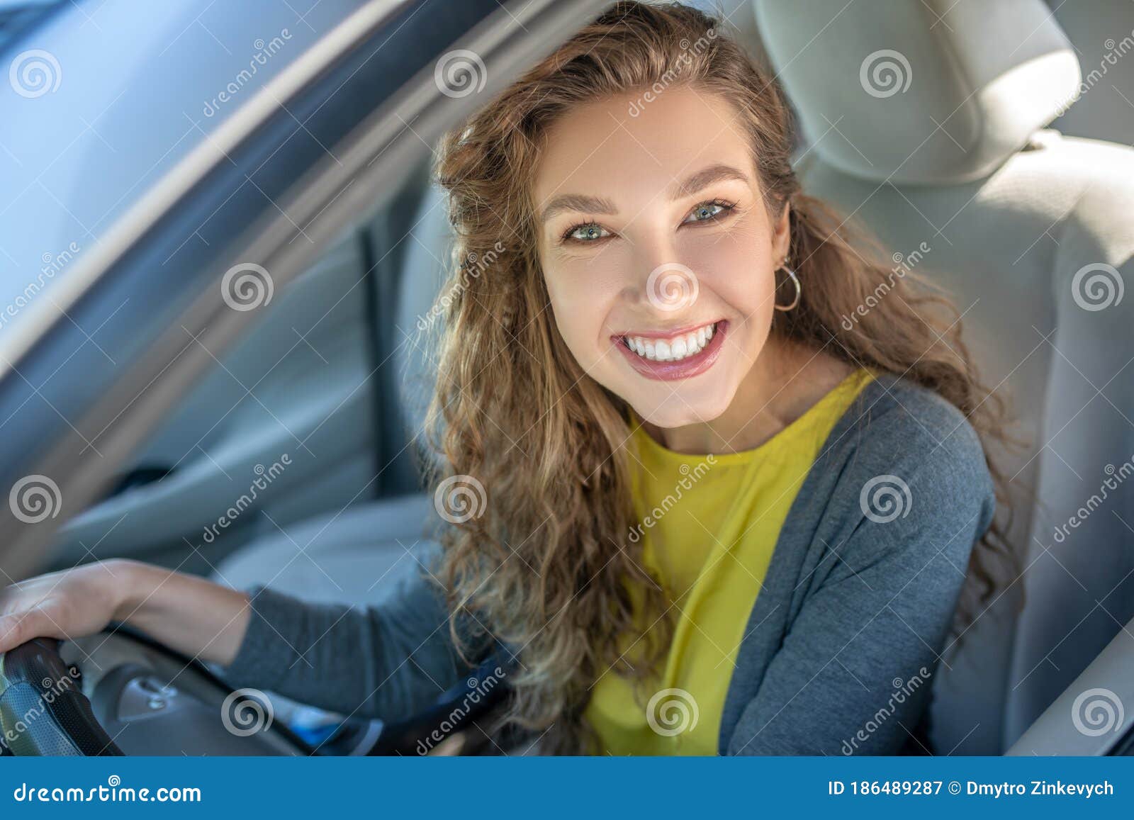 happy young smiling woman driving a car