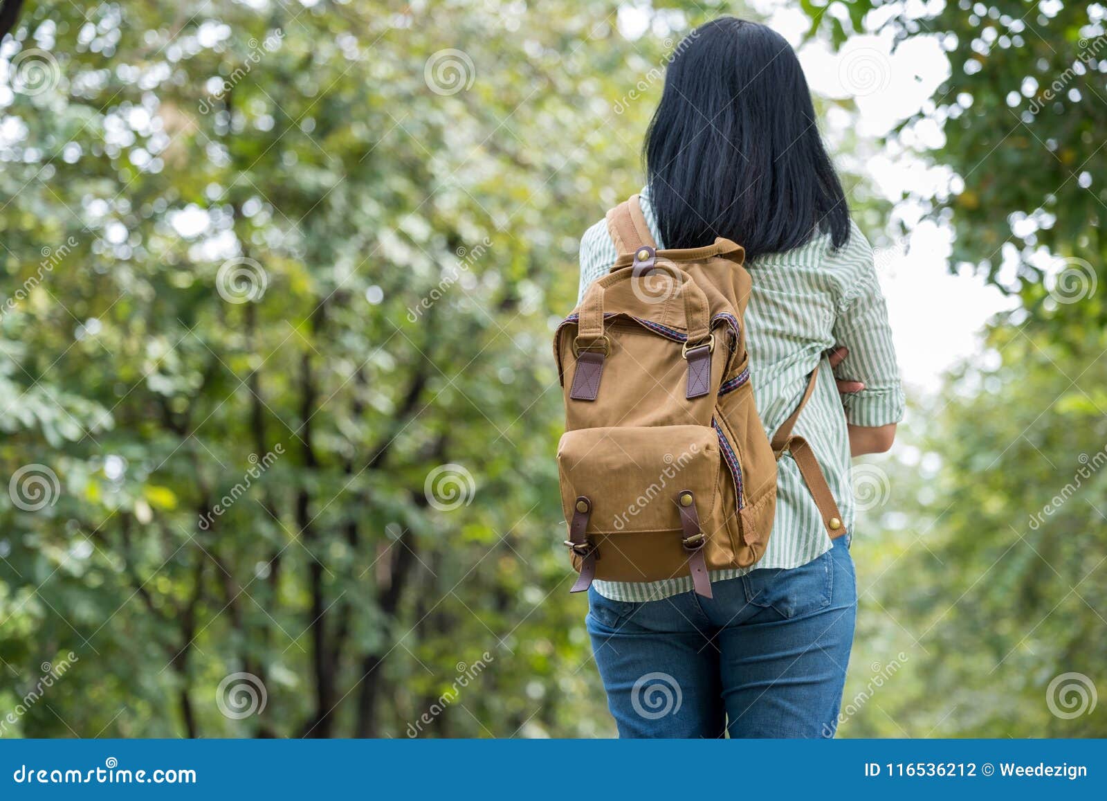 happy young traveler woman backpacker travel in green natural forest ,greenery fresh air,freedom wanderlust concept,alone solo jo