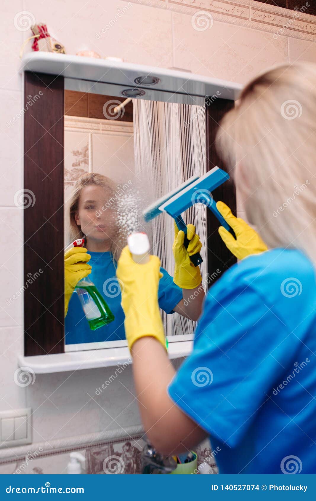 Woman Cleaning With Spray An