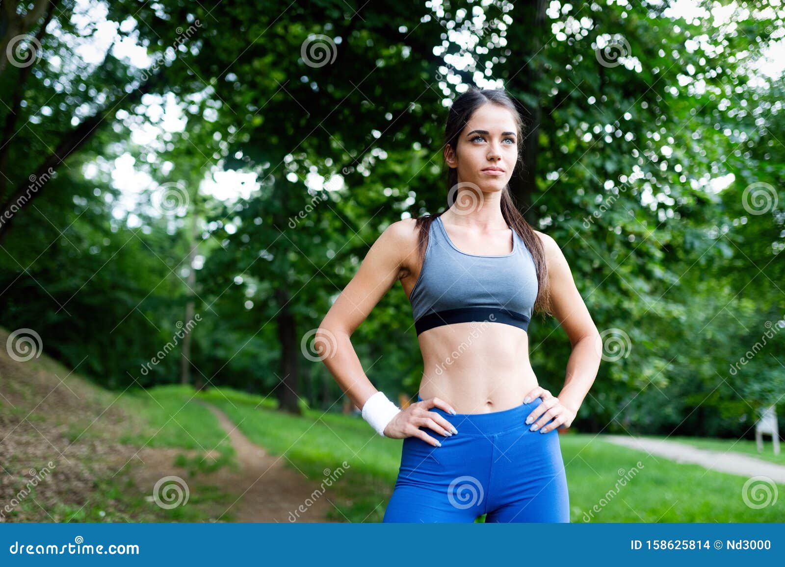 Happy Young Woman Doing Excercise Outdoor in a Park, Jogging Stock ...