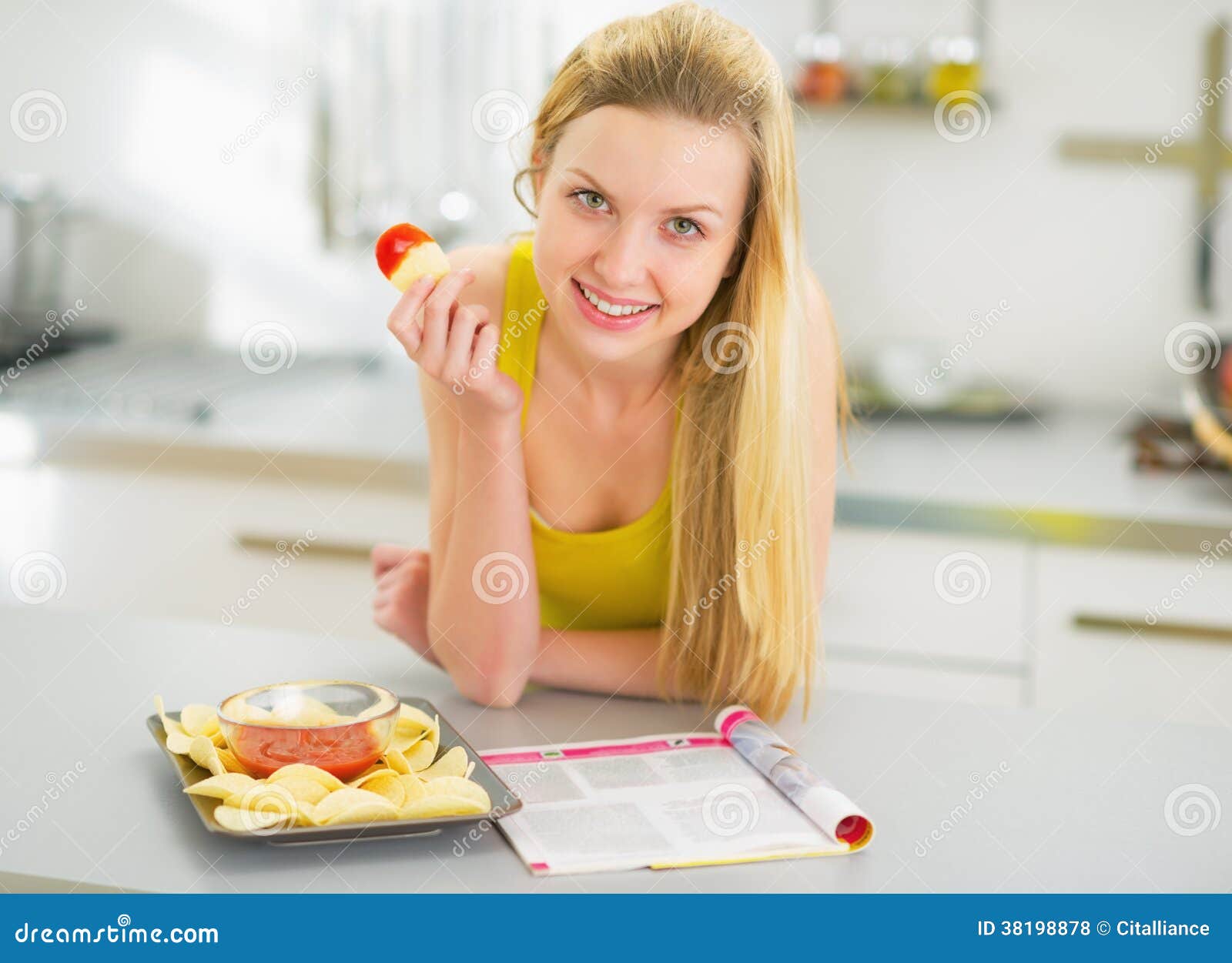 Happy Young Woman Eating Chips in Kitchen Stock Photo Image of fast
