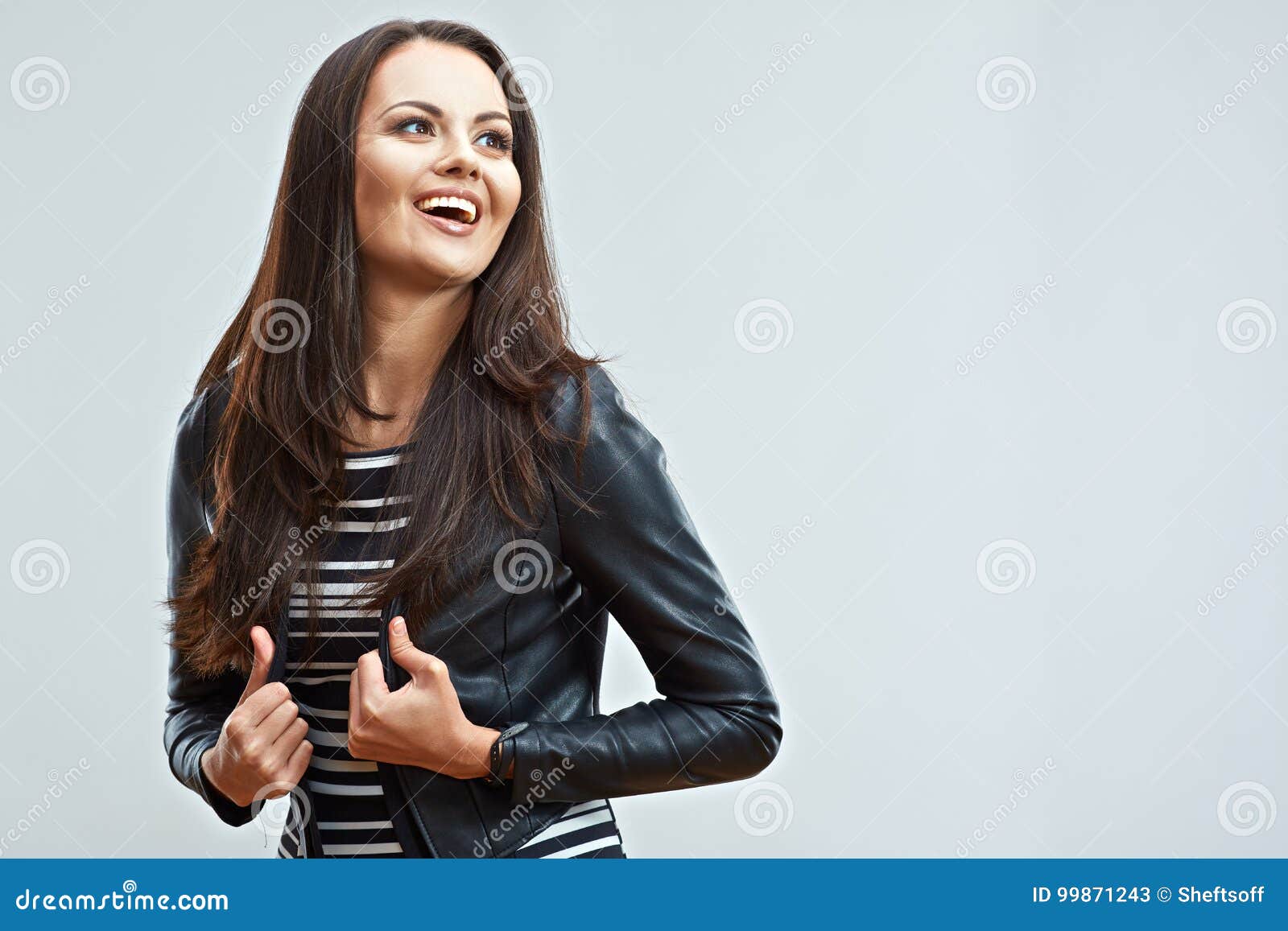 Happy young woman isolated portrait. Smiling emotional girl posing on isolated gray background.