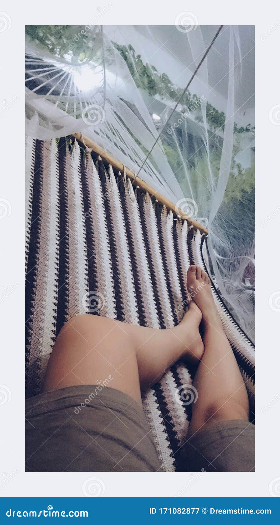 happy young woman lying on a hammock and relaxing