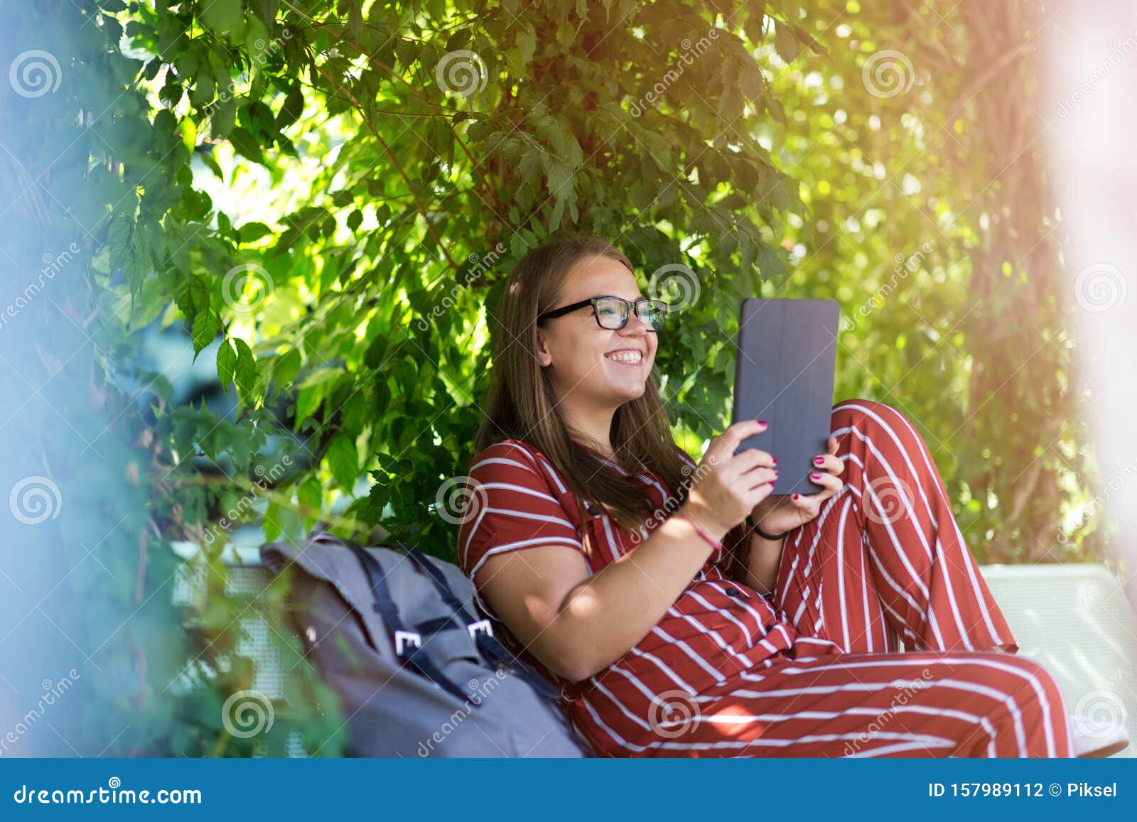 young woman with tablet computer in the park