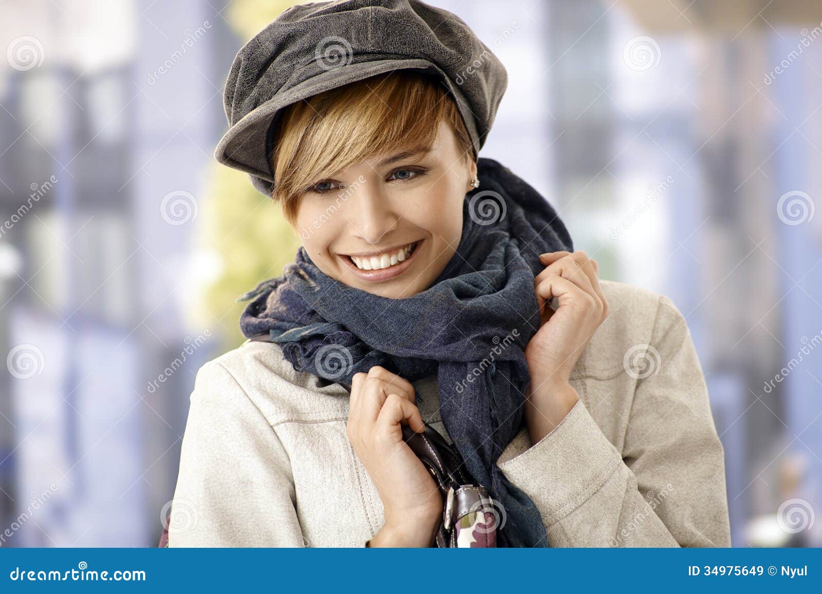 happy young woman wearing scarf and hat