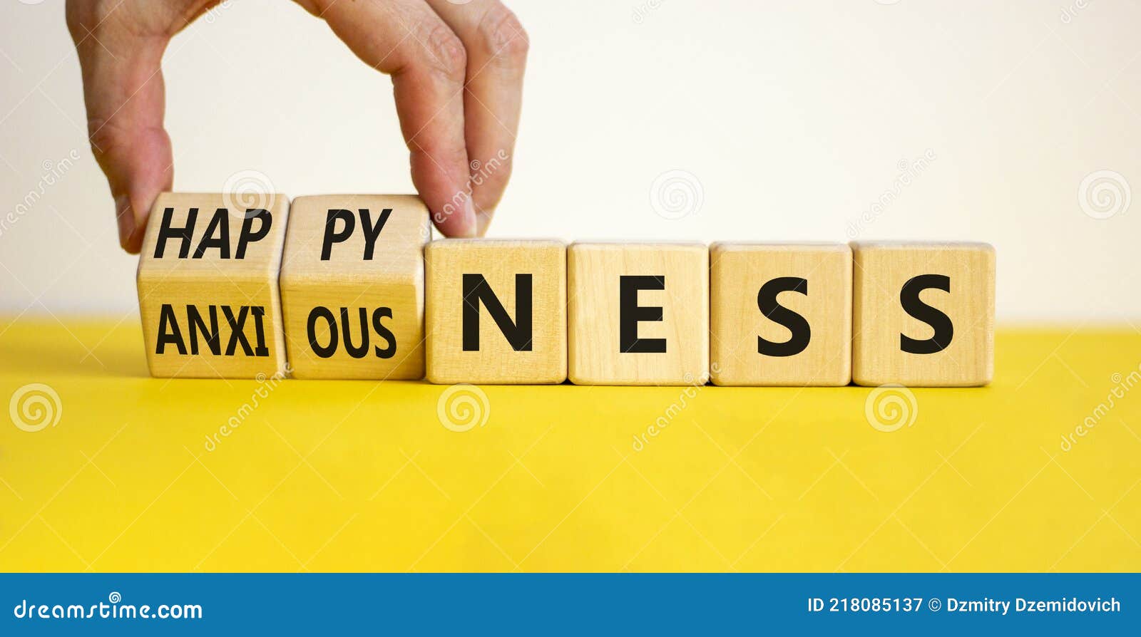 happyness or anxiousness. doctor turns cubes and changes the word `anxiousness` to `happyness`. beautiful yellow table, white