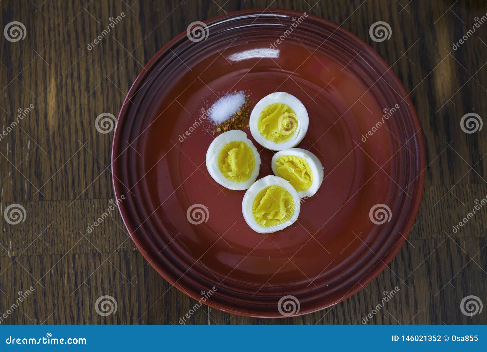 Hard Boiled Eggs Sliced in 2 with Pepper and Salt Stock Photo Image